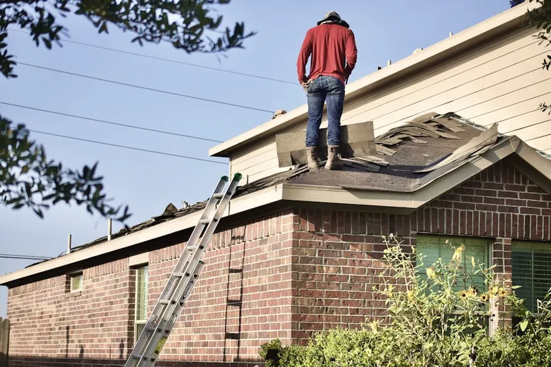 Professional roofer working on a residential roof in Verona Woods